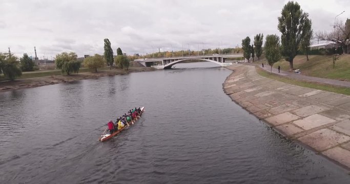 Aerial view of a young team of rowers exercising on the river. Top view of four athletes in a kayak. Training rowers on the river. Sporting Rowing Team Training. Rowing teams compete with each other. 