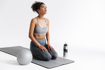 Amazing sports fitness african woman posing isolated over white background.