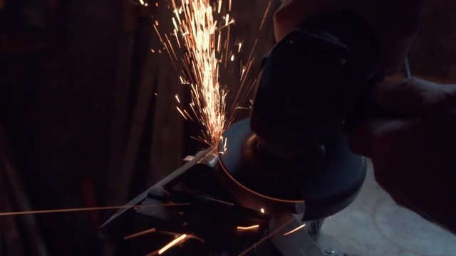 grinding of metal part with sparks