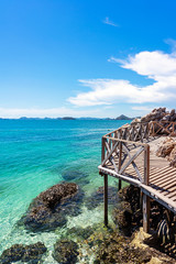 Wooden platform with clear turquoise sea and blue sky