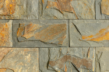 ramdom pattern of yellow brown stone wall decorate for background design 