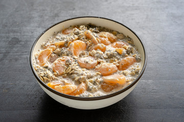 Muesli and yogurt with banana, mandarin, chia seeds and oat cereals, healthy food concept, close up