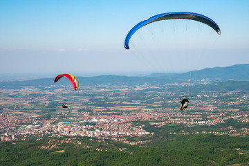 Loznica, Serbia April 21, 2019: Paraglider flying over mountains Gucevo and the Drina River. On the...