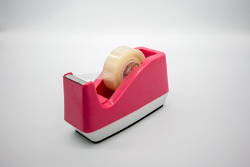 Pink Sellotape scotch tape dispenser isolated on white