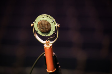 Microphone on stage against a background of auditorium.