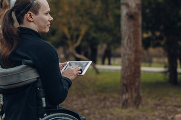 Fototapeta premium Portrait of a happy man on a wheelchair in a park
