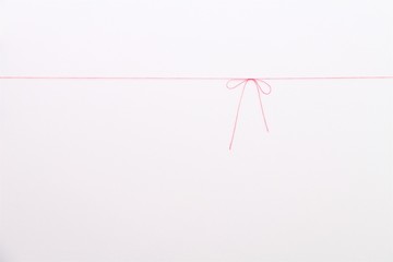 red thread on white background