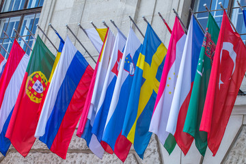 Flags of almost all countries of the northern hemisphere on the facade the building of Hofburg palace in Vienna, Austria.