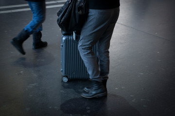 Man Walking on a Station with his Bag and Suitcase in Switzerland.