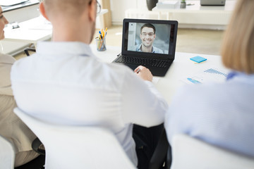 business, employment and technology concept - team of employers having video conference or job interview with new employee at office