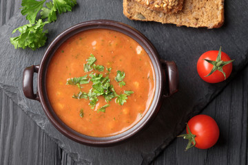 Vegetable soup, two cherry tomatoes, and two slices of bread