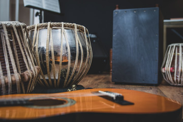 Acoustic guitar, cajon and tabla - view of the musical instruments used for fusion eastern and...