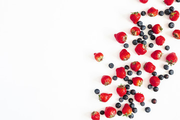 Strawberry and blueberry on white background. Flat lay, top view