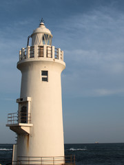 Fototapeta na wymiar lighthouse with blue sky background in summer