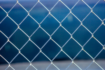 A metal fence foreground, with the background out of focus