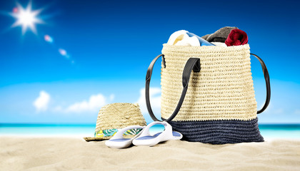 Summer beach background with summer bag on sand 