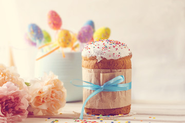 Easter festive background with Easter cake, eggs and flowers in a vintage style.