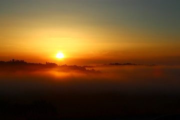 Sunrise, fog and hills