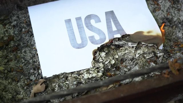 The inscription Google on a white A4 size sheet in the ash. The paper with black word burn, smoke and turns into ashes. The concept of war.