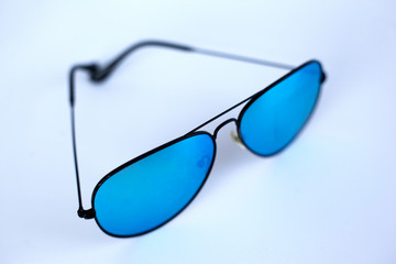 Blue mirrored sunglasses with anti-reflective coating and UV protection on a white background. 