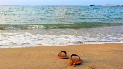  Brown shoes on the beach with turquoise water