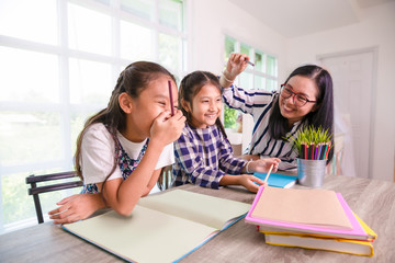 Young students girls having fun and enjoy studying with  teacher or mom in the class or at home