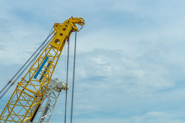 Crane lift yellow on blue sky background