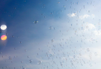 Soap bubbles fly in the blue sky