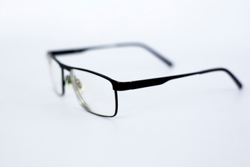 glasses for the visually impaired, poorly sighted.glasses with aspherical astigmatic lenses  in black frame on a white background.