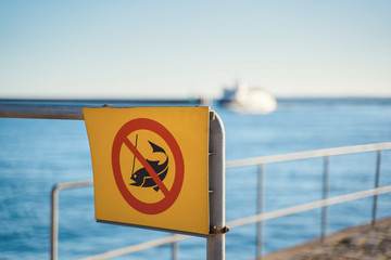 No fishing sign with blurred background with sea and ship