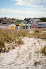 Fototapeta na wymiar Colorful beach huts with clouds in background. Falsterbo, sweden