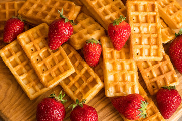 Close up of  belgian waffles with strawberries on the table 