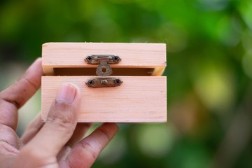 Wooden treasure box on hand