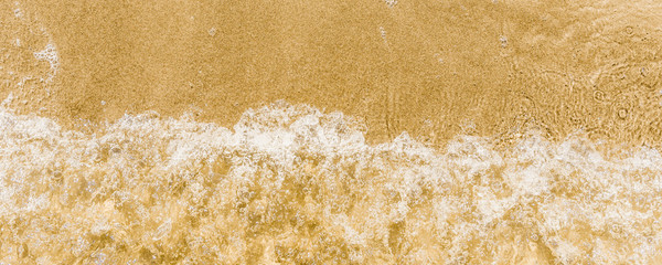 Wave and sandy seashore - panoramic background, top view, beach vacation, copy space