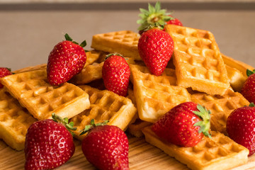Close up of  belgian waffles with strawberries on the table 