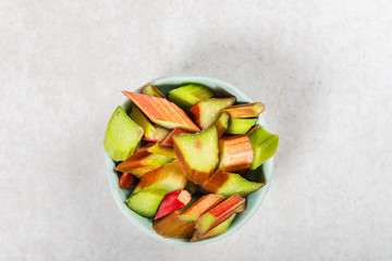 Pieces of Raw and Freshly Cut Rhubarb on Grey Background