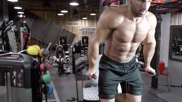 Young male bodybuilder doing a workout in the gym