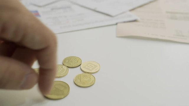 Bills to pay in background as a hand counts Israeli small change