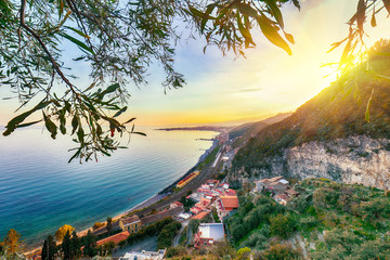 Aquamarine blue waters of sea near Taormina resorts and Etna volcano mount