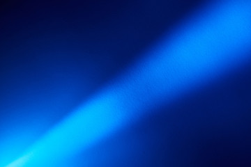 Bright beam of light on a dark background from the lower left corner to the upper right corner