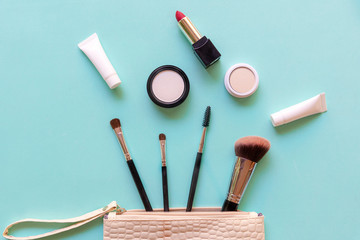 Makeup cosmetics tools and beauty cosmetics, products and facial cosmetics package lipstick, eyeshadow on green pastel background. Lifestyle Concept