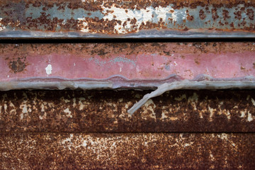 The rusty metal is caused by weather changes. Rust.
