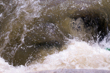 Fototapeta premium Dirty mountain river. Dirty water in river after rain.