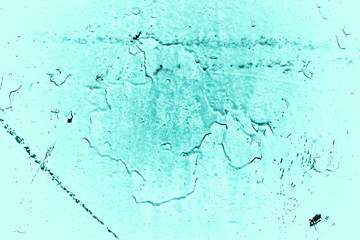 Vintage azure background. Rough painted wall of turquoise color. Imperfect plane of cyan colored. Uneven old decorative toned backdrop of aqzure tint. Texture of teal hue. Ornamental stony surface.