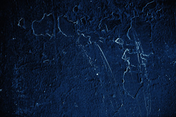 Vintage blue background. Rough painted wall of sapphire color. Imperfect plane of blue colored. Uneven old decorative toned backdrop of cyan tint. Texture of sapphirine hue. Ornamental stony surface.