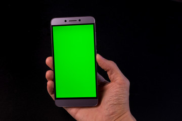 hand holding smart phone with blank screen isolated on white