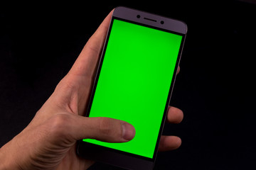hand holding smart phone with blank screen isolated on white