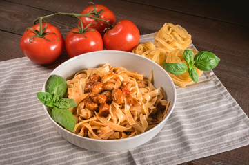 Italian spaghetti and meatballs topped with fresh basil