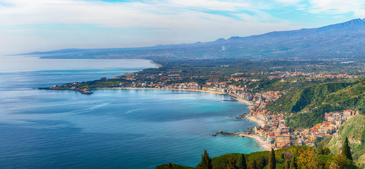 Aquamarine blue waters of sea near Taormina resorts and Etna volcano mount