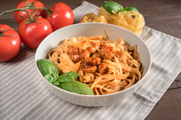 Italian spaghetti and meatballs topped with fresh basil